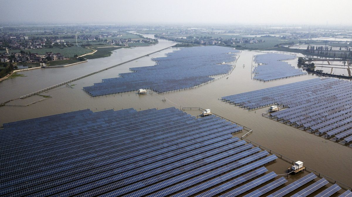 Photovoltaic panels stand at a solar farm operated by China Energy Conservation and Environmental Protection Group in this aerial photograph taken on the outskirts of Jiaxing, Zhejiang province, China.