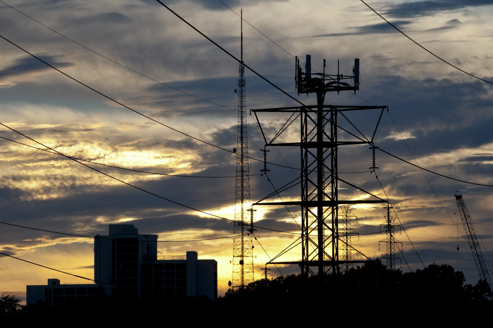 Power transmission lines suspended from a pylon that also serves as phone tower in Clifton, New Jersey