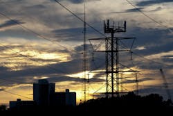 Power transmission lines suspended from a pylon that also serves as phone tower in Clifton, New Jersey Power transmission lines suspended from a pylon that also serves as phone tower in Clifton, New Jersey