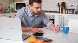 Man calculating bills and tax expenses