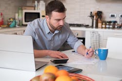 Man calculating bills and tax expenses Man calculating bills and tax expenses