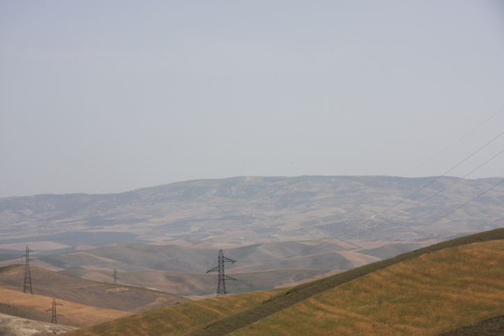 Electric transmission towers and overhead lines on slopes