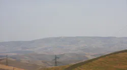 Electric transmission towers and overhead lines on slopes