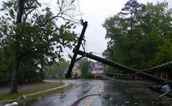 A damaged pole with hanging power lines A damaged pole with hanging power lines