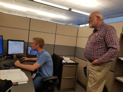 Dean Stange assists a distribution designer Dean Stange assists a distribution designer