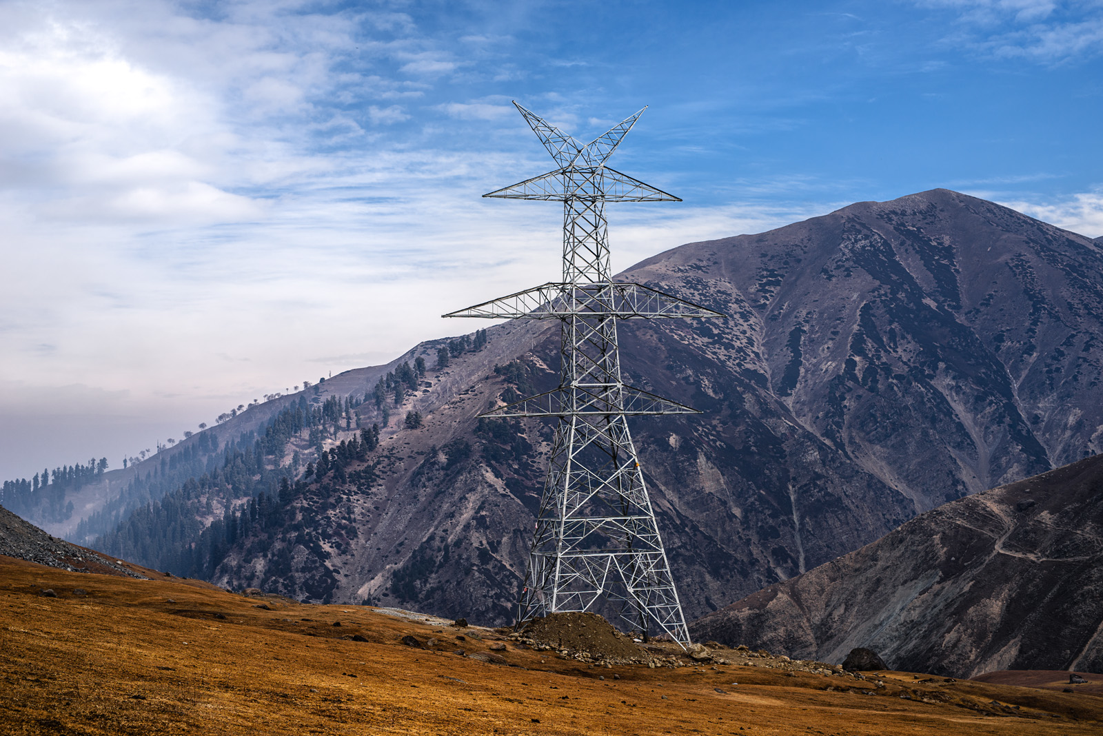 Electric transmission tower on mountainous terrain