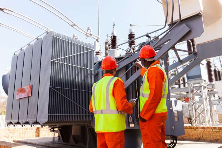 workers in front of transformer