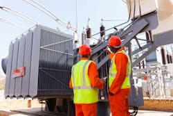 workers in front of transformer workers in front of transformer