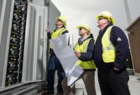 Ameren Illinois employees inspect a new energy storage system that is part of the company&rsquo;s microgrid project. Construction on the Ameren microgrid was completed in December 2016, followed by testing in the first quarter of 2017.