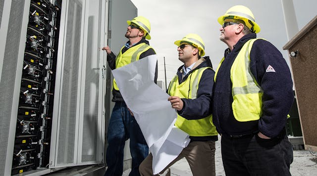 Ameren Illinois employees inspect a new energy storage system that is part of the company&rsquo;s microgrid project. Construction on the Ameren microgrid was completed in December 2016, followed by testing in the first quarter of 2017.