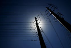 Nightscape showing an electric pole with overhead lines Nightscape showing an electric pole with overhead lines