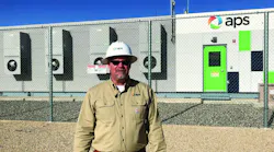 APS' director of Technology Innovation stands in front of APS' energy storage battery