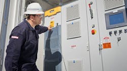 A man operating a battery storage unit A man operating a battery storage unit