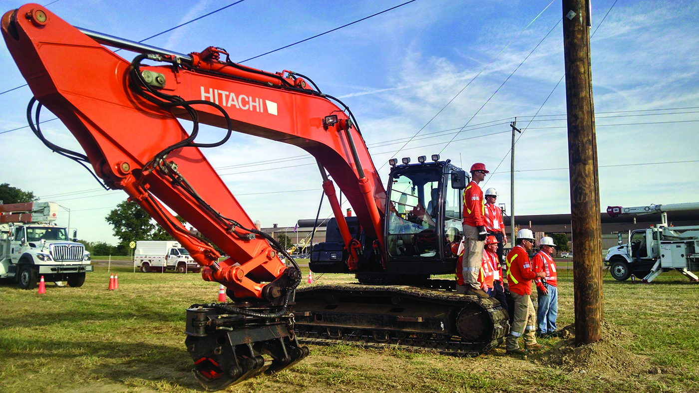 A crane with workers standing around it in an outdoor site