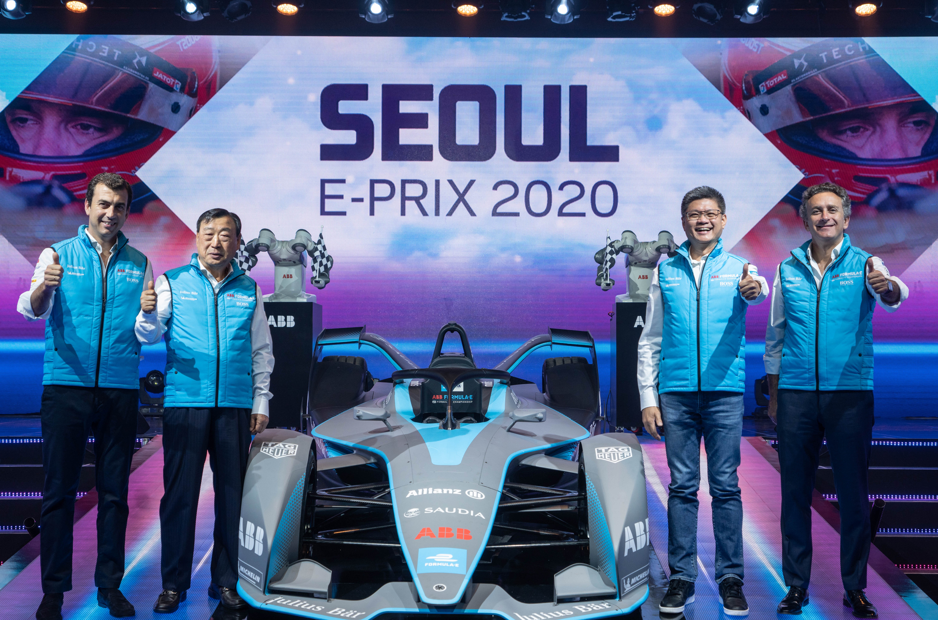 Robot waving checkered flags to unveil the Gen2 car at a media conference in Seoul