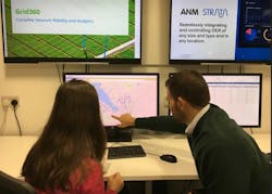 People discussing data on a computer People discussing data on a computer