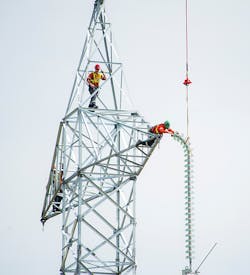 Insulators for one of the poles on a Bipole III HVDC structure being delivered by a helicopter Insulators for one of the poles on a Bipole III HVDC structure being delivered by a helicopter
