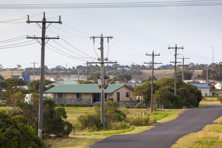Electric poles and overhead lines alongside a road