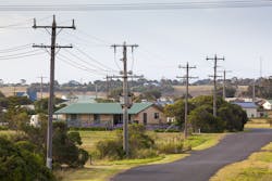 Electric poles and overhead lines alongside a road Electric poles and overhead lines alongside a road