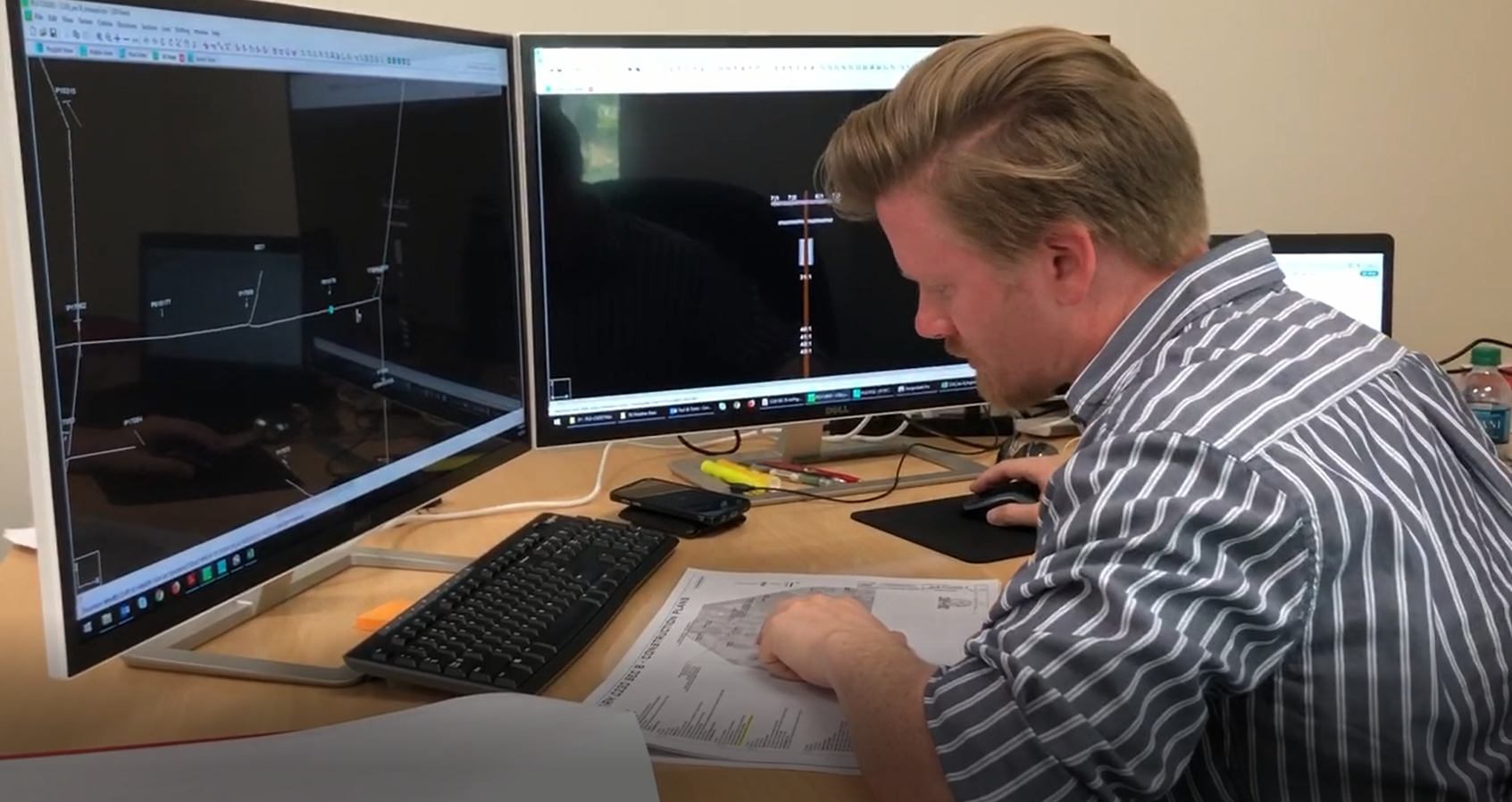 A man working on data in front of computers