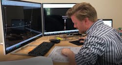 A man working on data in front of computers A man working on data in front of computers