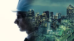 A composite image of an engineer's face and an illuminated city scape A composite image of an engineer's face and an illuminated city scape