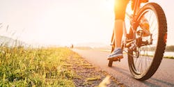 A cyclist pedaling down the road A cyclist pedaling down the road
