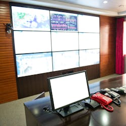 A utility control room with a computer, microphone, and telephones A utility control room with a computer, microphone, and telephones