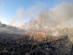 Electric transmission towers obscured by smoke from a wildfire Electric transmission towers obscured by smoke from a wildfire