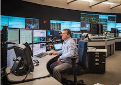 A man working in a grid control center A man working in a grid control center