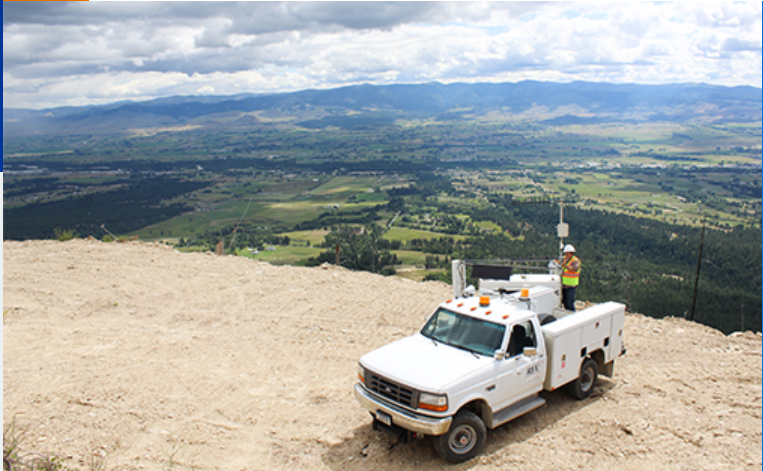 A truck with mountains in the background