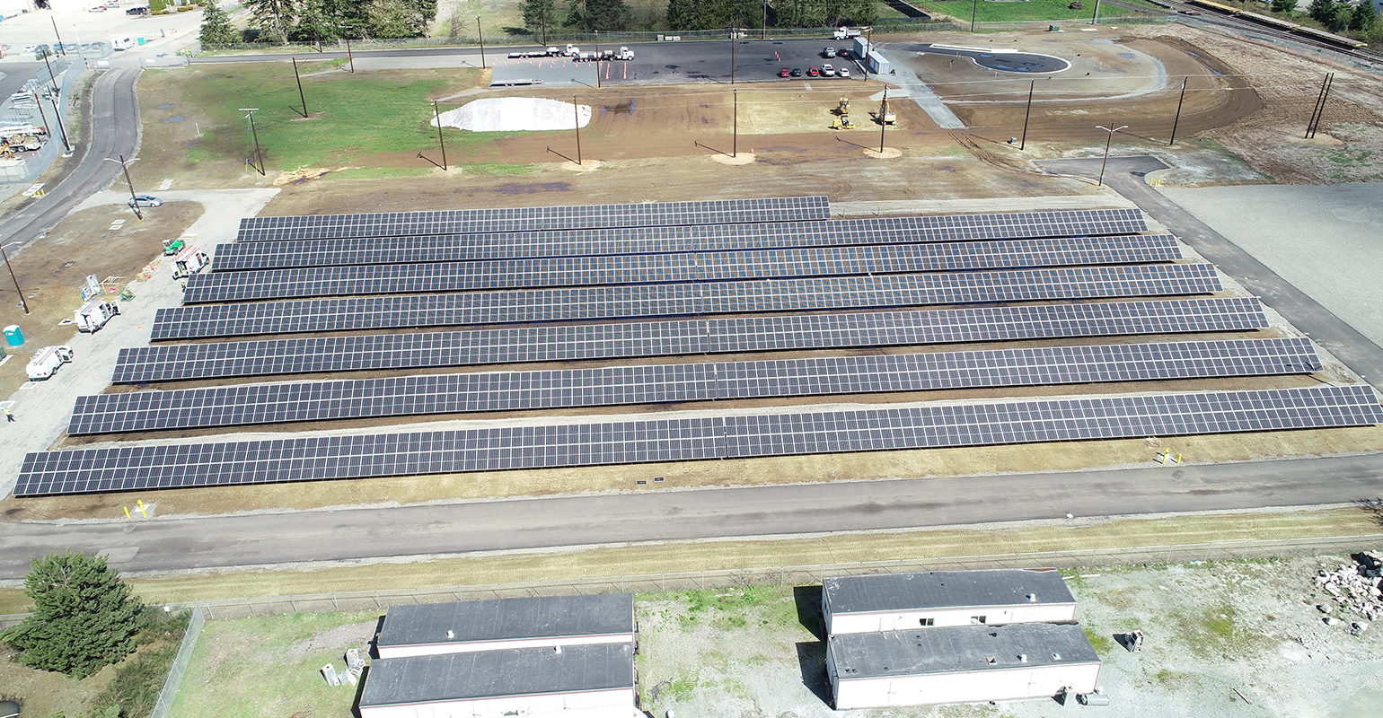 An overhead view shows the 500-kW Community Solar array nearing completion