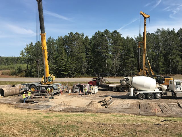 Workers prepare a drilled pier site to receive concrete. Most of the foundations and anchors were helical piles, but some sites required concrete, steel-reinforced, drilled pier foundations.