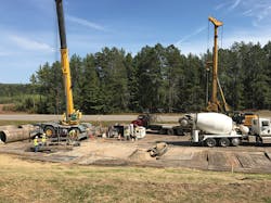 Workers prepare a drilled pier site to receive concrete Workers prepare a drilled pier site to receive concrete