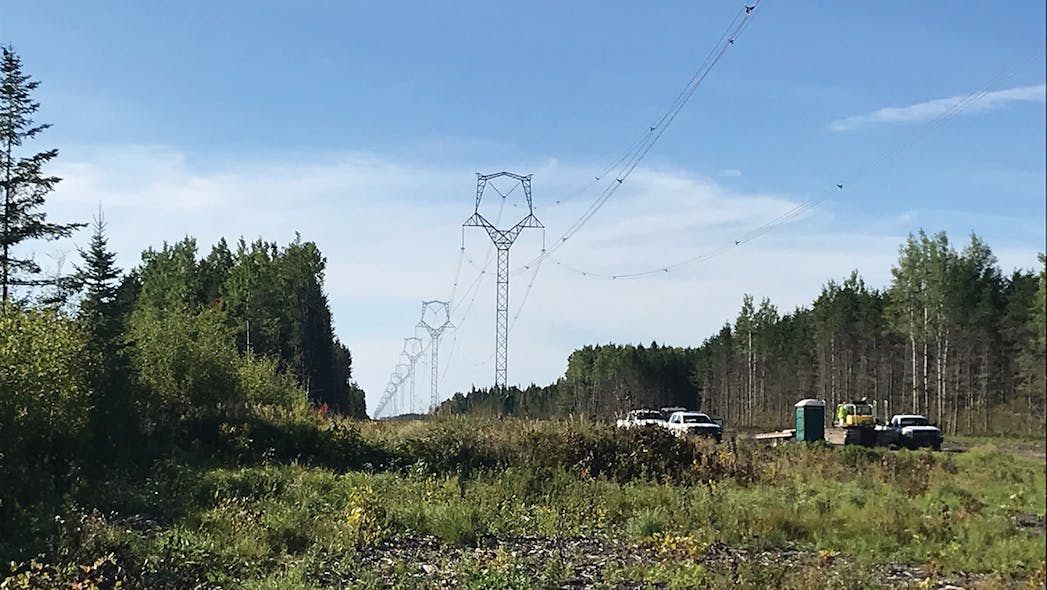A summertime view of a completed section of the transmission line.