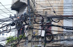 Entangled electric wires on an electric pole Entangled electric wires on an electric pole
