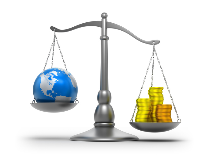 A weighing scale with a globe and coins on either arm