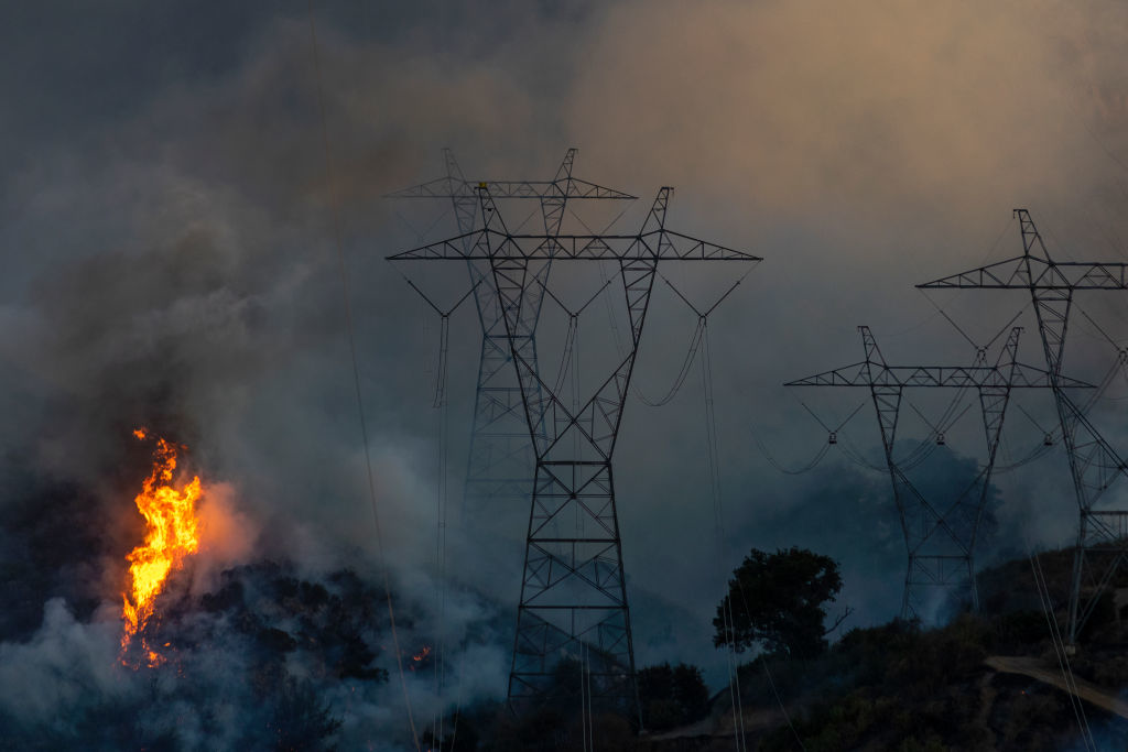 A wildfire near electric transmission towers and overhead lines