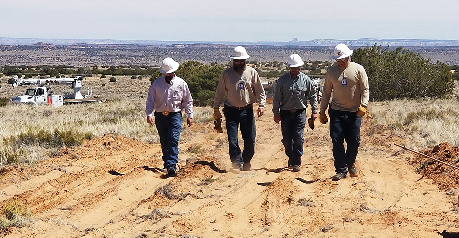 Heber City linemen team walks planned electric power line route to a hogan, a traditional Navajo dwelling