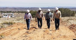 Heber City linemen team walks planned electric power line route to a hogan, a traditional Navajo dwelling, located 10 miles (16 km) off the main highway in Northern Arizona.