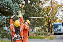 Utility workers restoring service after windstorm Utility workers restoring service after windstorm