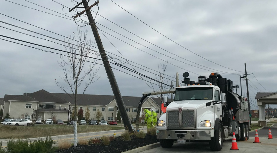 Utility workers on trucks assisting in storm restoration
