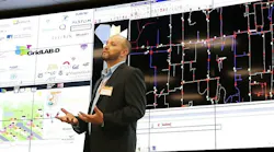 Man discussing data on digital screens