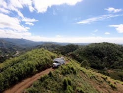 Power lines span mountain peaks in Puerto Rico, making restoration challenging. Power lines span mountain peaks in Puerto Rico, making restoration challenging.