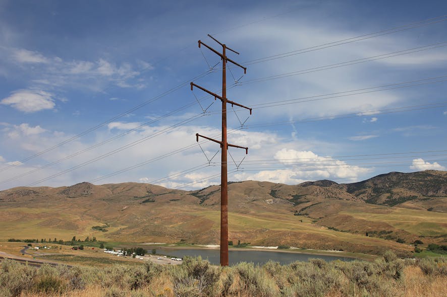 A weathering steel pole blends with colors of the background mountains and surrounding area.