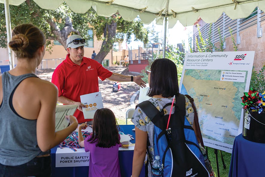 SDG&amp;E representative meeting with community members at the SDG&amp;E Wildfire Safety Fair.