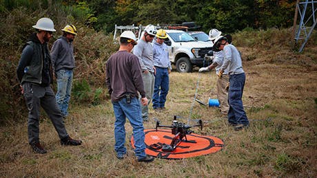 Members of BPA&rsquo;s Ross transmission line maintenance crew Aircraft Services test the drone to ensure it has the power and capability to fly and maneuver with a sock line attached.