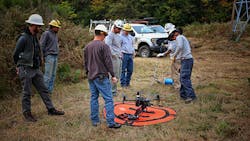 Members of BPA’s Ross transmission line maintenance crew Aircraft Services test the drone to ensure it has the power and capability to fly and maneuver with a sock line attached. Members of BPA’s Ross transmission line maintenance crew Aircraft Services test the drone to ensure it has the power and capability to fly and maneuver with a sock line attached.