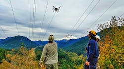 BPA&rsquo;s transmission line crew receives sock line from the quadcopter under the de-energized portion of the Lolo Pass line.