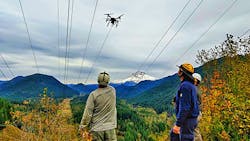 BPA’s transmission line crew receives sock line from the quadcopter under the de-energized portion of the Lolo Pass line. BPA’s transmission line crew receives sock line from the quadcopter under the de-energized portion of the Lolo Pass line.
